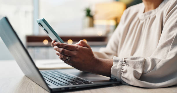 istock Hands, phone or business person typing email, text message or network on laptop in creative startup. Keyboard, mobile or worker on chat app for research, check forum or review article for publication 2177607106