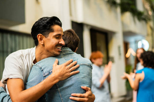 Young man embracing friend outdoors