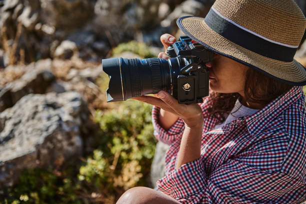 istock Woman photographer with camera outdoors in natural setting 2177613591