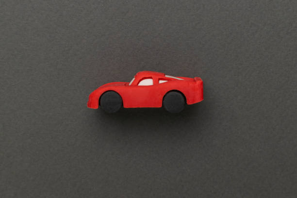istock Minimalist Red Toy Car on Dark Green Background in Artistic Composition 2177617937