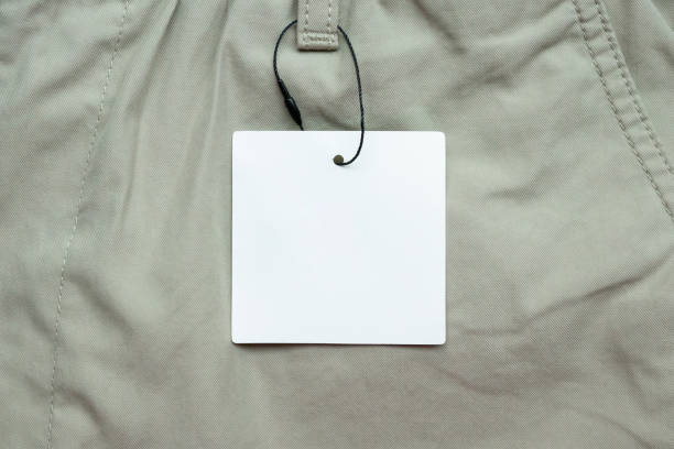 istock Blank white clothes tag label on gray fabric texture background 2177618300