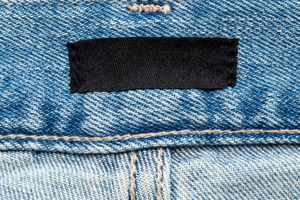 istock blank clothes label on blue jeans denim background 2177618311