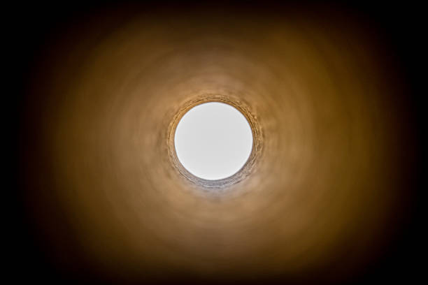 Looking down the length of a corrugated steel pipe.