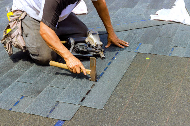 istock An installation worker using an air pneumatic nail gun installed new bitumen shingles on a roof 2177618621