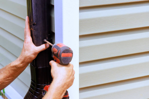 istock An employee installing rain gutter on roof with is installing a downpipe, downspout bend 2177618655