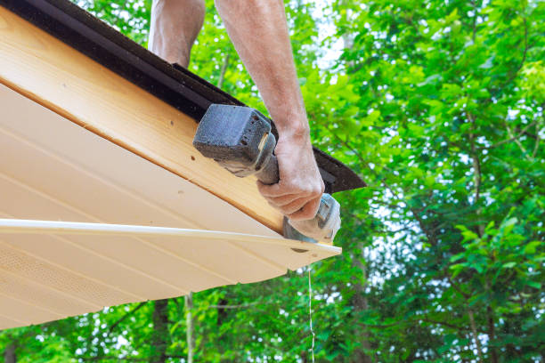 istock Cutting off existing vinyl soffit plastic panels on new house facade ceiling to a specific size 2177618675