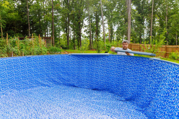 istock Constructing a swimming pool in backyard of house 2177618781