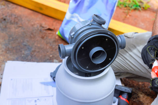 istock Worker installing sand filter system tank a equipment for cleaning swimming pools 2177618788