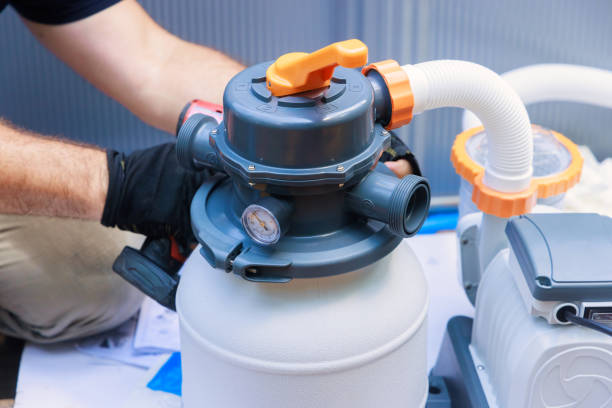 istock Worker assembling a sand filter system tank, equipment for cleaning swimming pools 2177618799