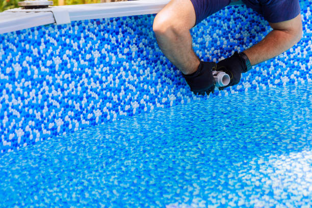 istock Maintenance service worker installs water filtration system, chlorination in a frame pool 2177618822