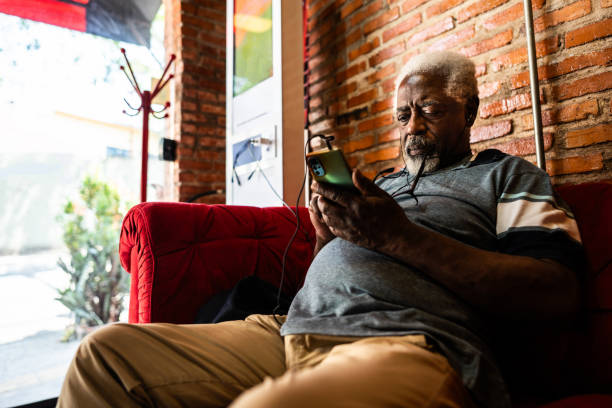 istock Senior man using the mobile phone at a barber shop 2177619142