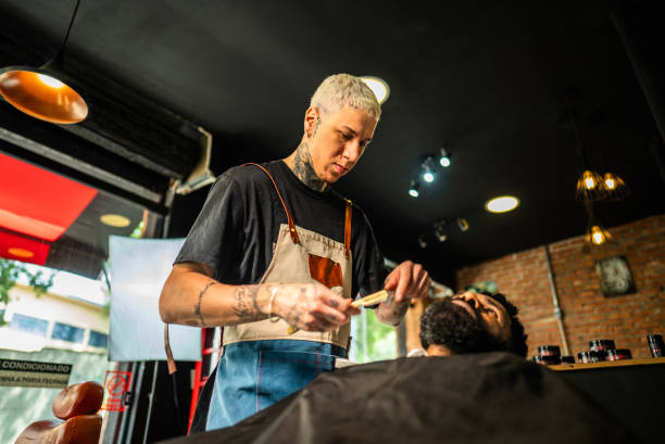 istock Barber shaving the customer's beard at a barber shop 2177619301