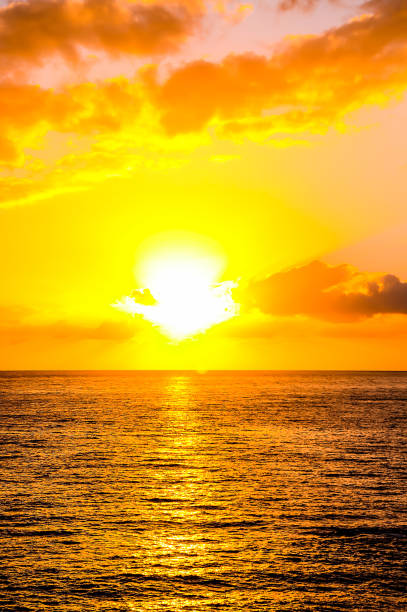 istock The sun is setting over the ocean, casting a warm glow on the water 2177619759