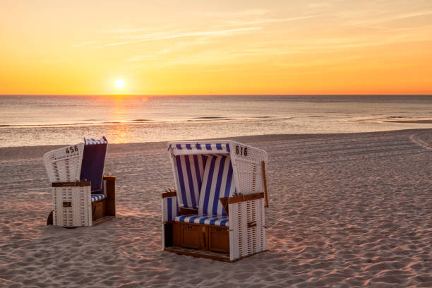 Beach chairs at North Sea beach of Hornum, Sylt, in sunset