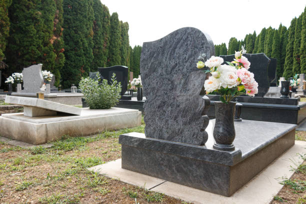 istock granite tombstones in cemetery with flowers 2177620885