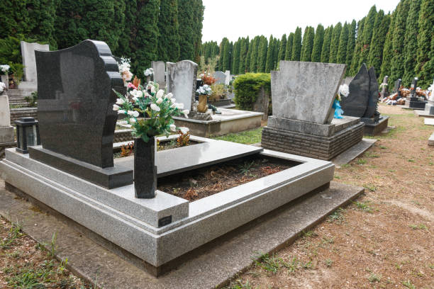 istock granite tombstones in cemetery with flowers 2177620957