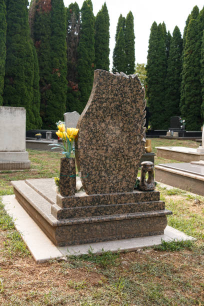 istock granite tombstones in cemetery with flowers 2177621475