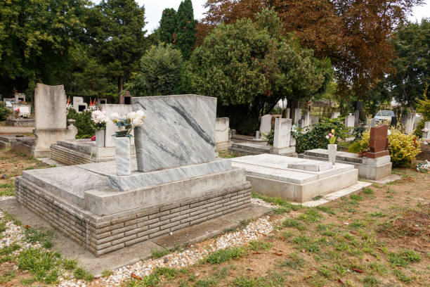 istock graves with flowers in a green cemetery 2177622058