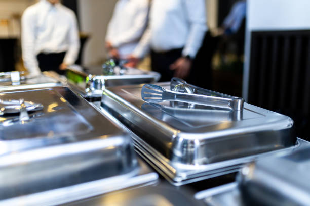 istock Catered buffet setup featuring metallic serving trays at a formal event in an elegant venue during the evening 2177623467