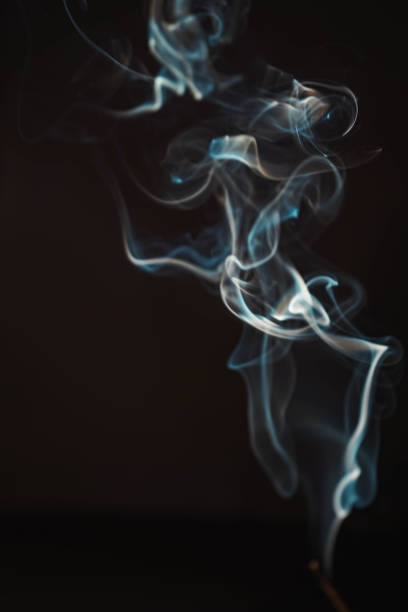 istock Aroma sticks smoke on black background with white backlit. Burning aromatic incense smoky stick for meditation and relaxing. Incense burning smoke fumes and wisps. Aromatherapy smokes for yoga. 2177623562