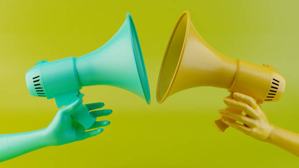 istock Dual Perspectives: Two Hands Holding Colorful Megaphones Facing Each Other 3D Rendering 2177624430
