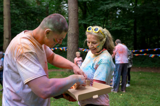 istock Duo Covered in Paint Sharing Pizza Post Colour Run 2177624539