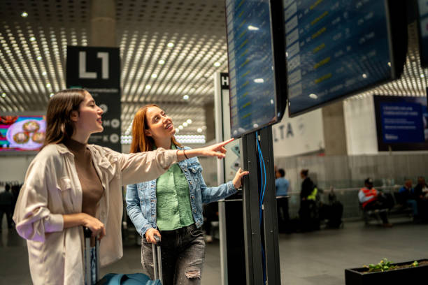 istock Friends women looking control panel at airport 2177626528