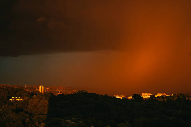 Evening city in storme weather. Thunderous clouds