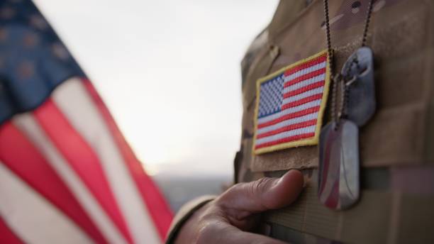 American Serviceman Puts USA Flag On Chest During Memorial Day Holiday