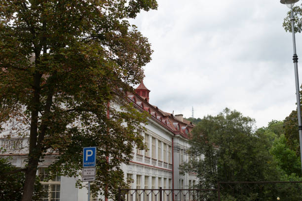 istock A large white building with a red roof and blue P sign in front 2177629362