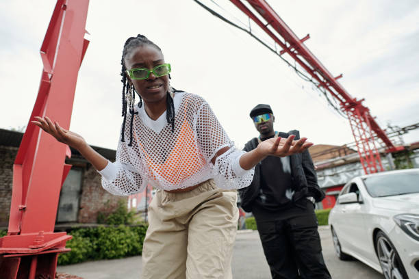istock Gesturing Woman with Sunglasses and Man in Background 2177630893