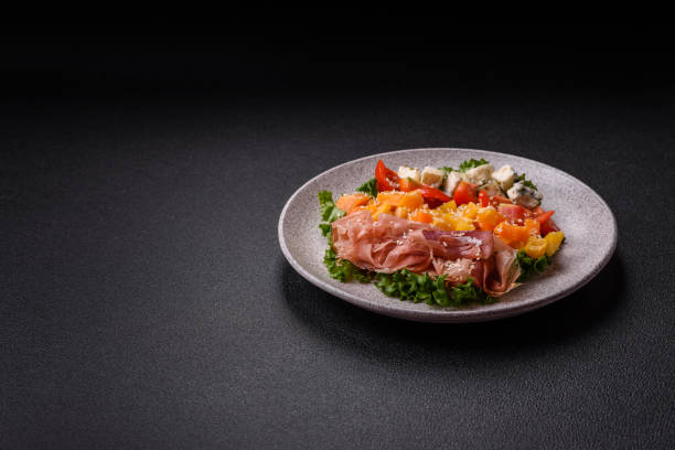 istock Appetizing salad with prosciutto, pumpkin, cheese and tomatoes 2177631396