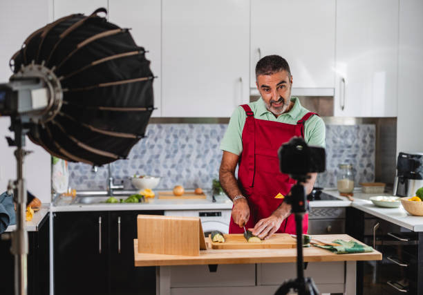 istock Senior man recording cooking show streaming live video from kitchen 2177632895
