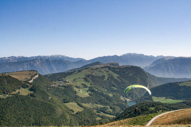 istock Paragliding into green mountains 2177633979