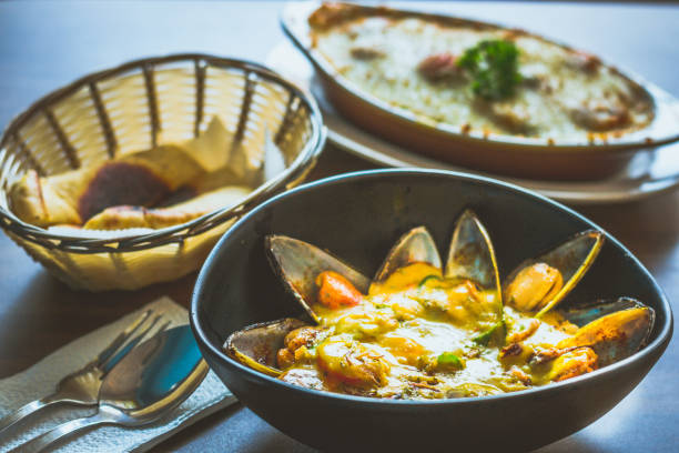 Curry Mussels in a bowl and Served with pita bread