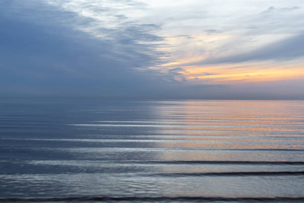 Sunset behind the clouds on baltic sea in summer