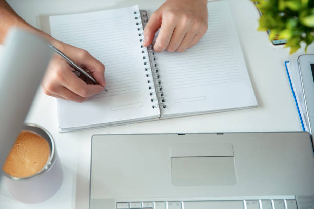 istock Closeup shot of a young man writing on a note pad 2177637232