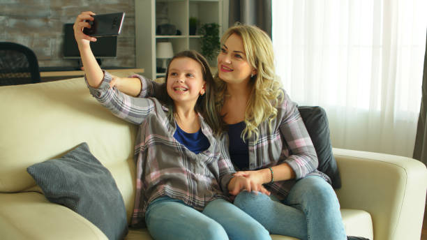 istock Mother and daughter making funny faces 2177638795
