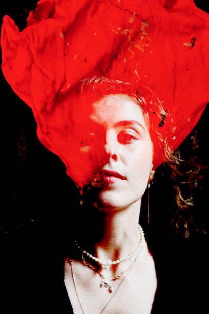 Rehearsals for a play.  This image has a female actress around 25 years old with only her face lit and looking down.