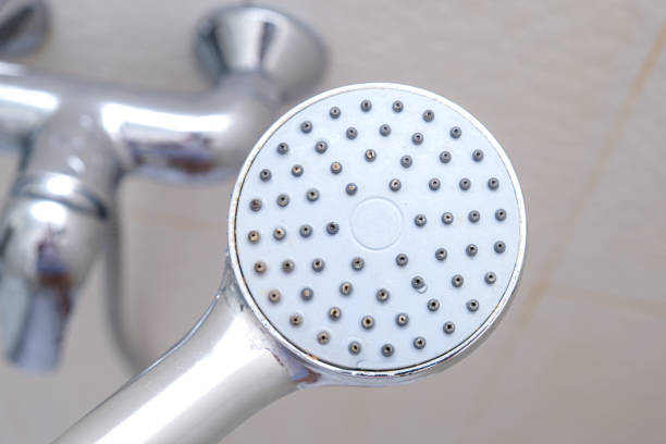 Clean shower head and a water tap on background, everyday routine, self hygiene concept