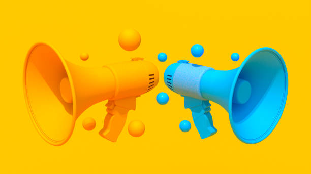istock Orange and blue megaphones, 3D render, vibrant yellow background, floating spheres, minimalist, symmetrical, high-contrast geometric shapes, abstract communication concept, clean modern aesthetic. 2177645978