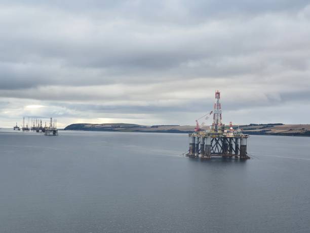 Row of Oil Rigs with overcast Sky