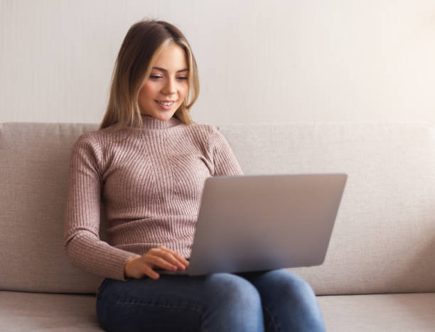istock Young woman browsing on laptop at home 2177649297