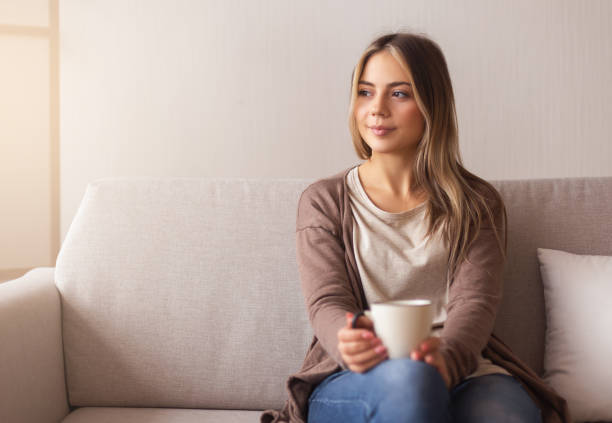 istock Millennial girl drinking hot coffee at home 2177649334
