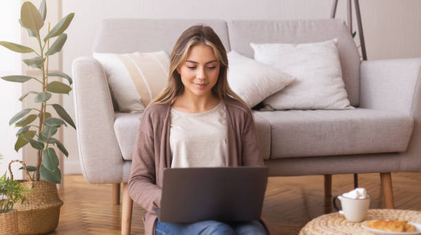 istock Young woman browsing on laptop at home 2177649400