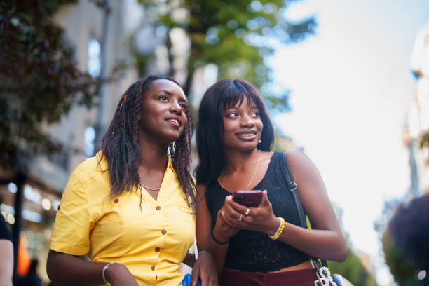 istock Two black young female using mobile phone in downtown city streets. 2177649446