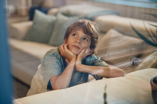 Portrait of a beautiful boy day dreaming.