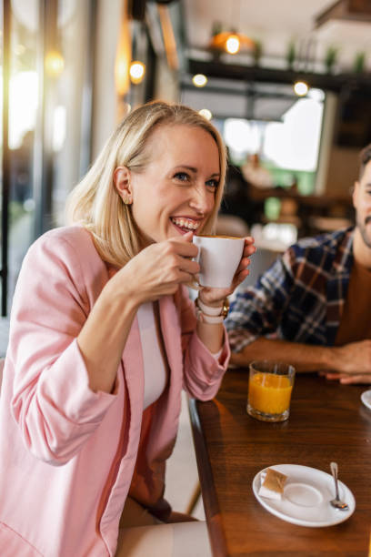istock Young cheerful woman drinking hot drink in a restaurant. 2177650144