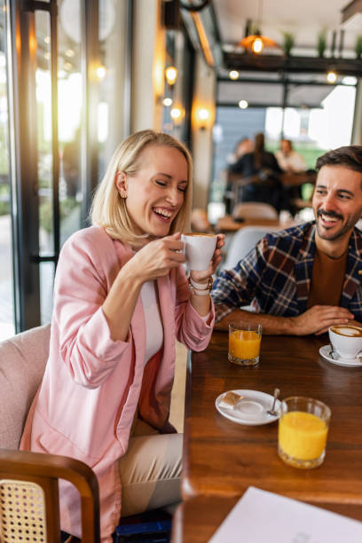 istock Young cheerful woman drinking hot drink in a restaurant. 2177650213