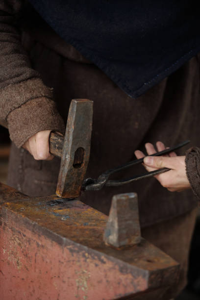 istock Person Forging Metal with Hammer and Anvil 2177650721